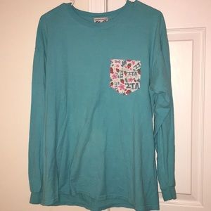 Light blue long sleeve ZTA shirt.